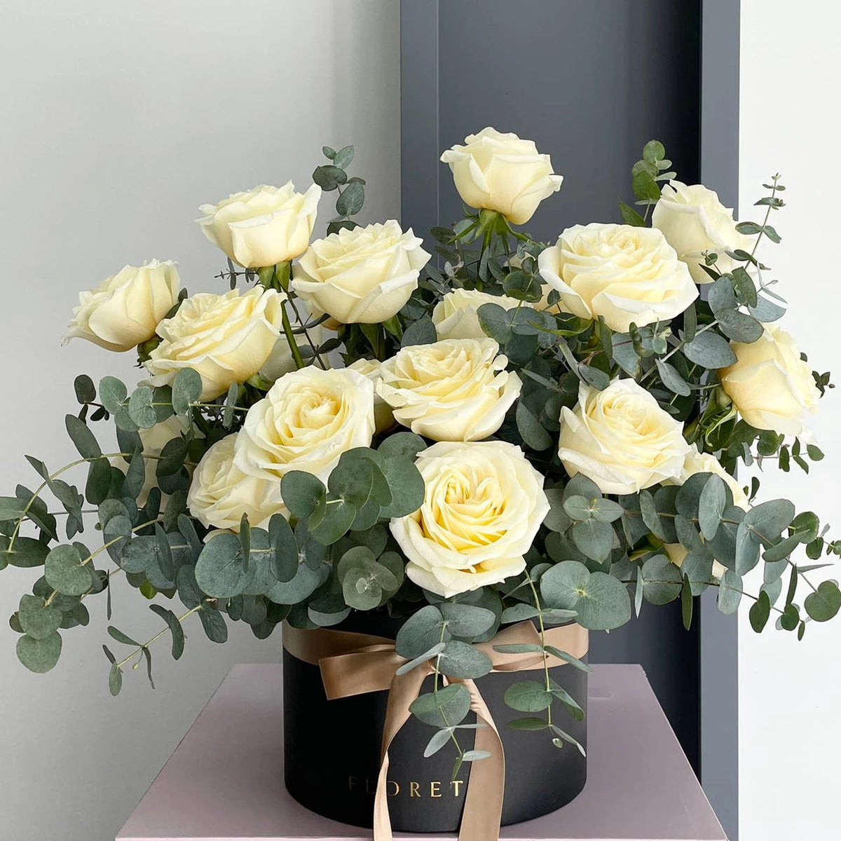 Florette's classic and elegant ROME medium floral box arrangement with 15 white roses and eucalyptus cinerea.
