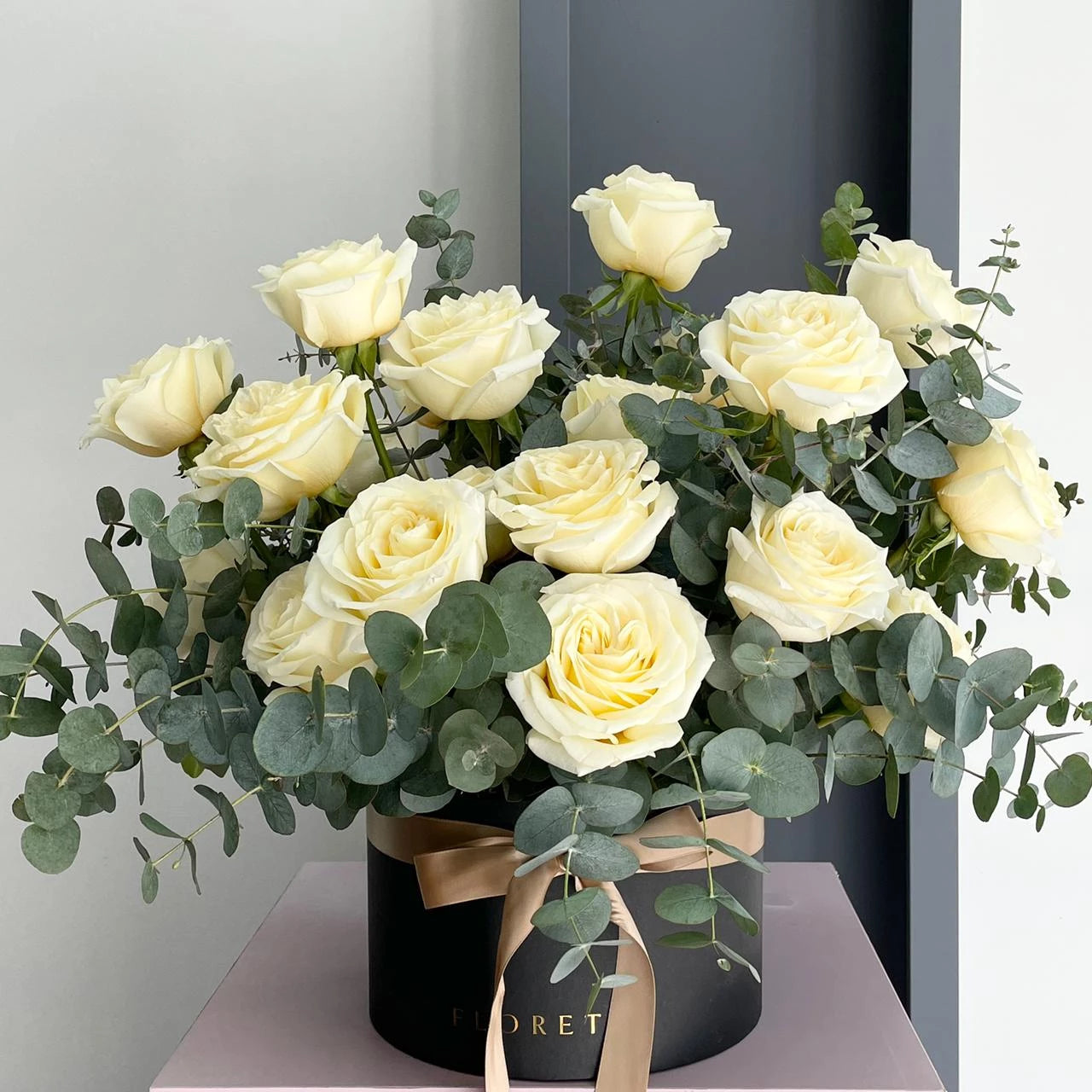 Florette's classic and elegant ROME medium floral box arrangement with 15 white roses and eucalyptus cinerea.