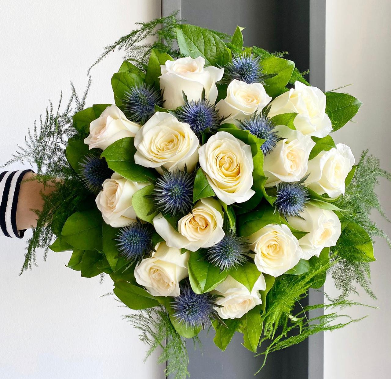 Florette NICE - A bouquet with lots of beautiful white garden roses, blue eryngiums, asparagus, and lemon leaves.